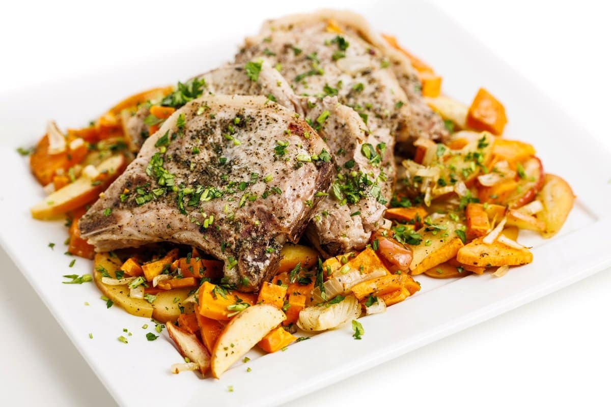 Sheet pan pork chops with apples, onions, and sweet potatoes.