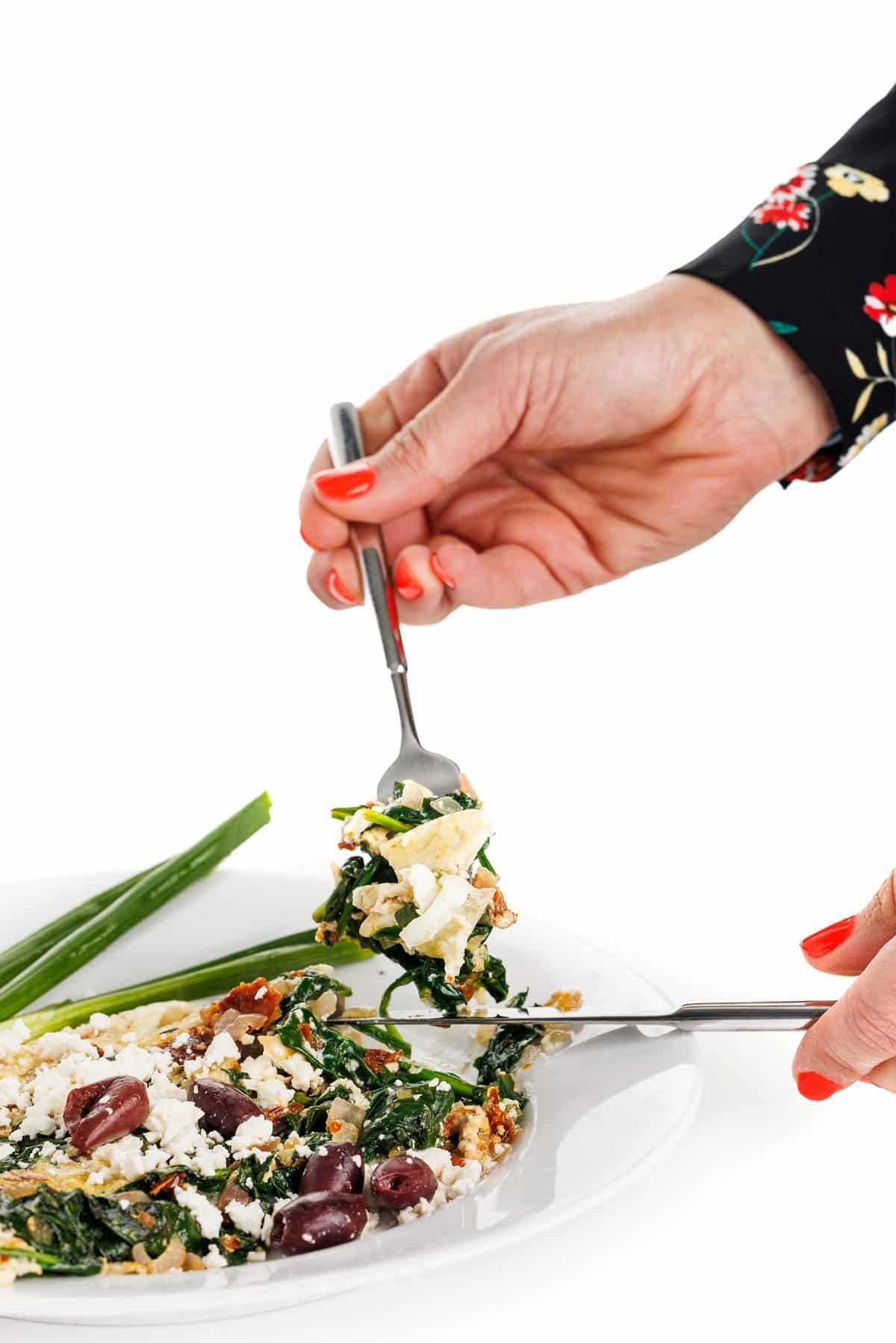 Forkful of feta and spinach egg white omelette.