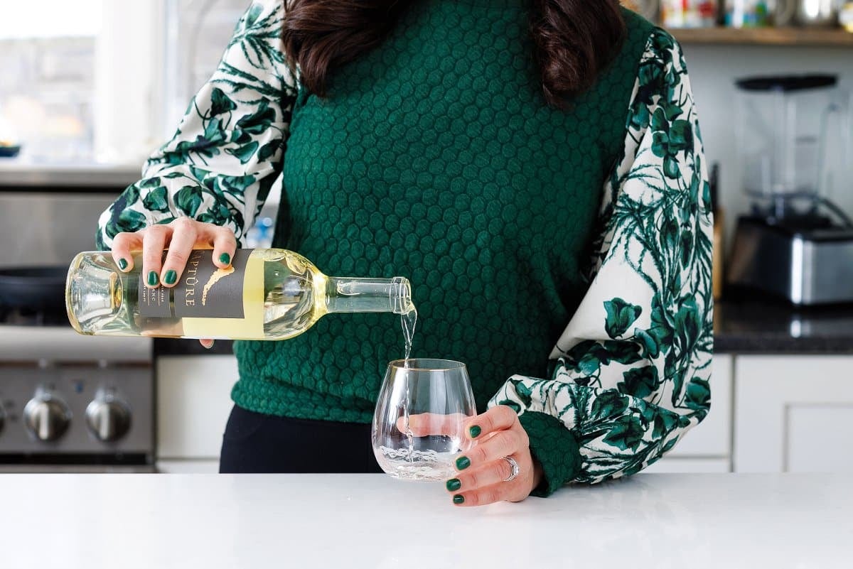 Liz pouring capture wine.