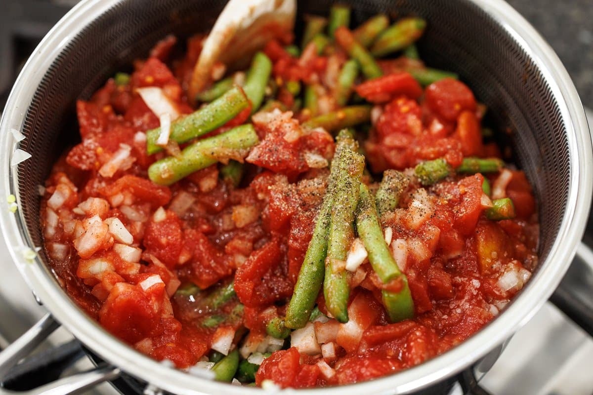 Stewed green beans cooking in pot.