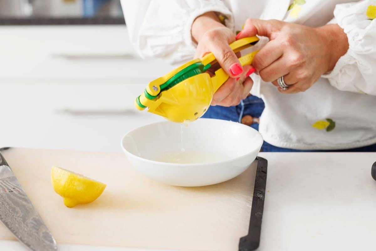 Liz squeezing lemon juice into a bowl.
