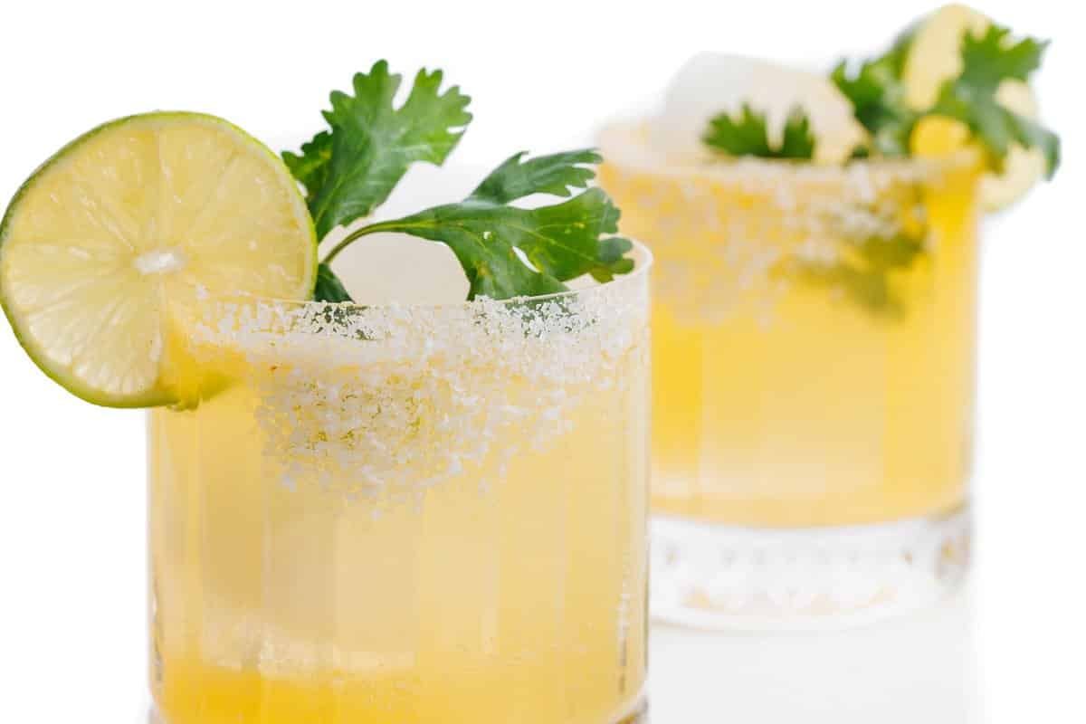 Two cilantro margaritas with salted rims.