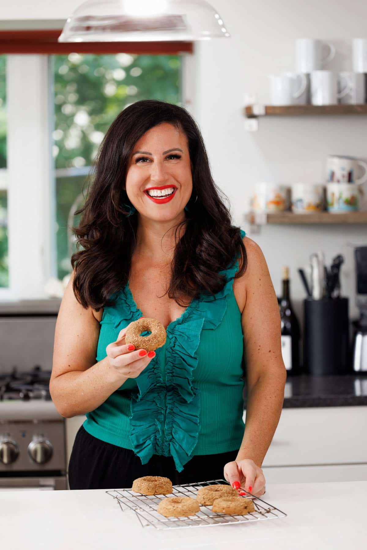 Liz eating baked apple cider donuts.