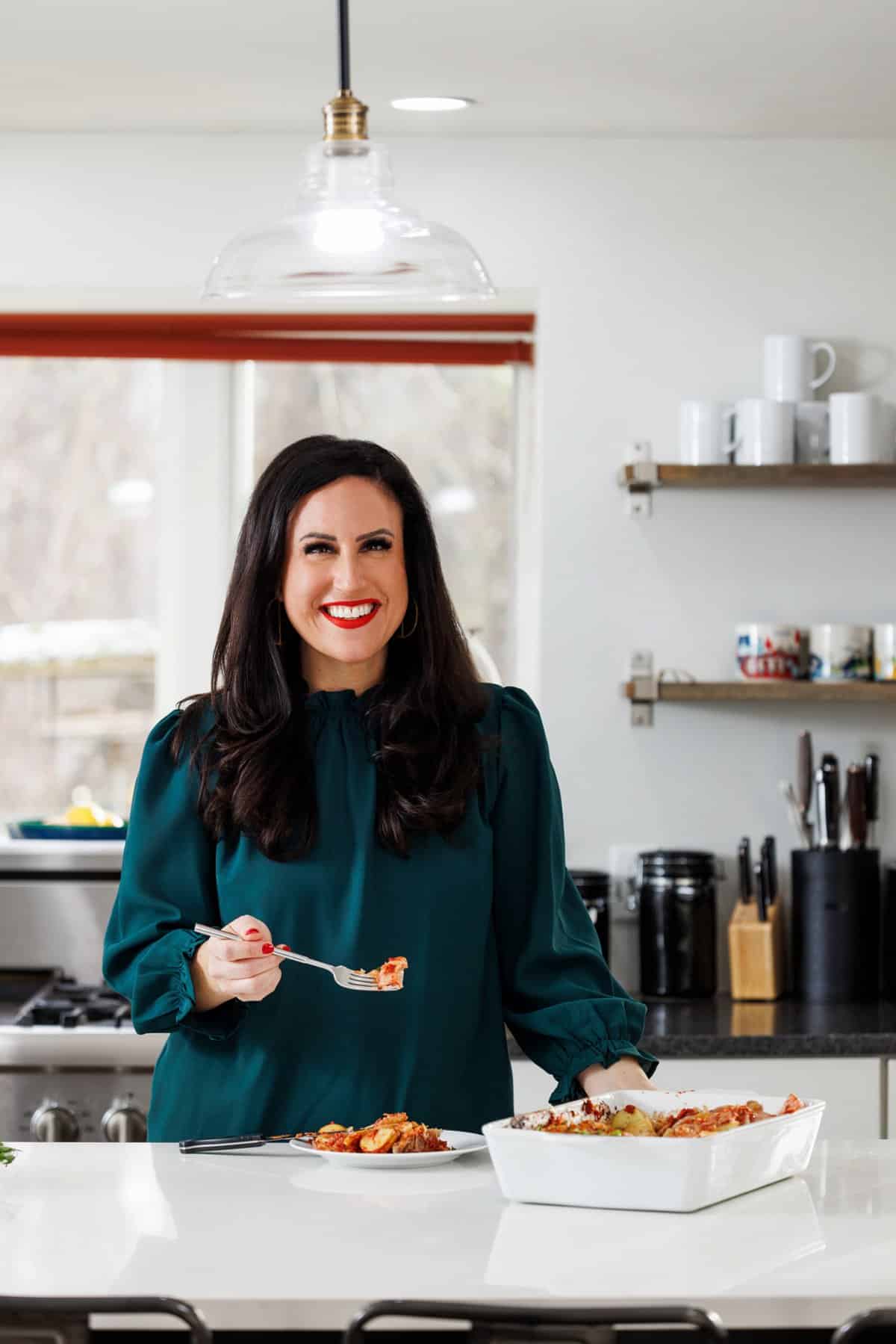 Liz eating oven baked pork chops with sauerkraut and potatoes.
