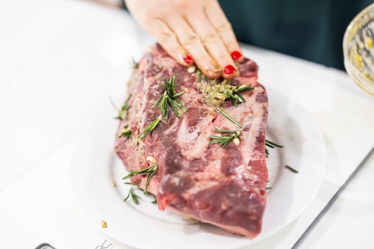 Rubbing garlic, olive oil, salt mix all over roast.
