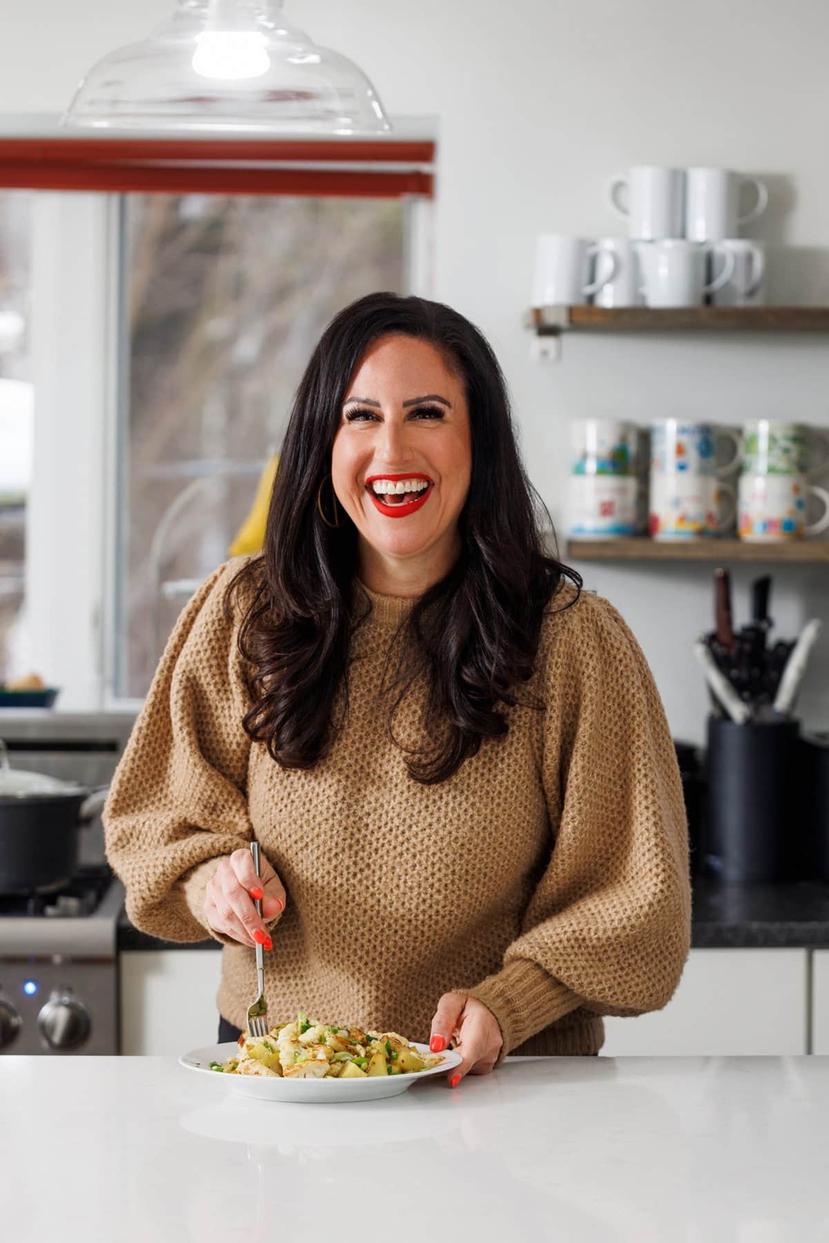Liz eating garlic roasted potatoes and cauliflower.
