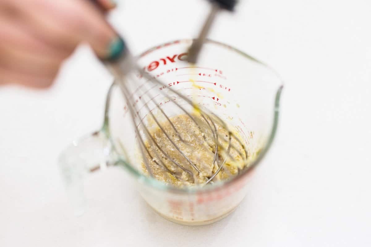 Whisking dressing in measuring cup.