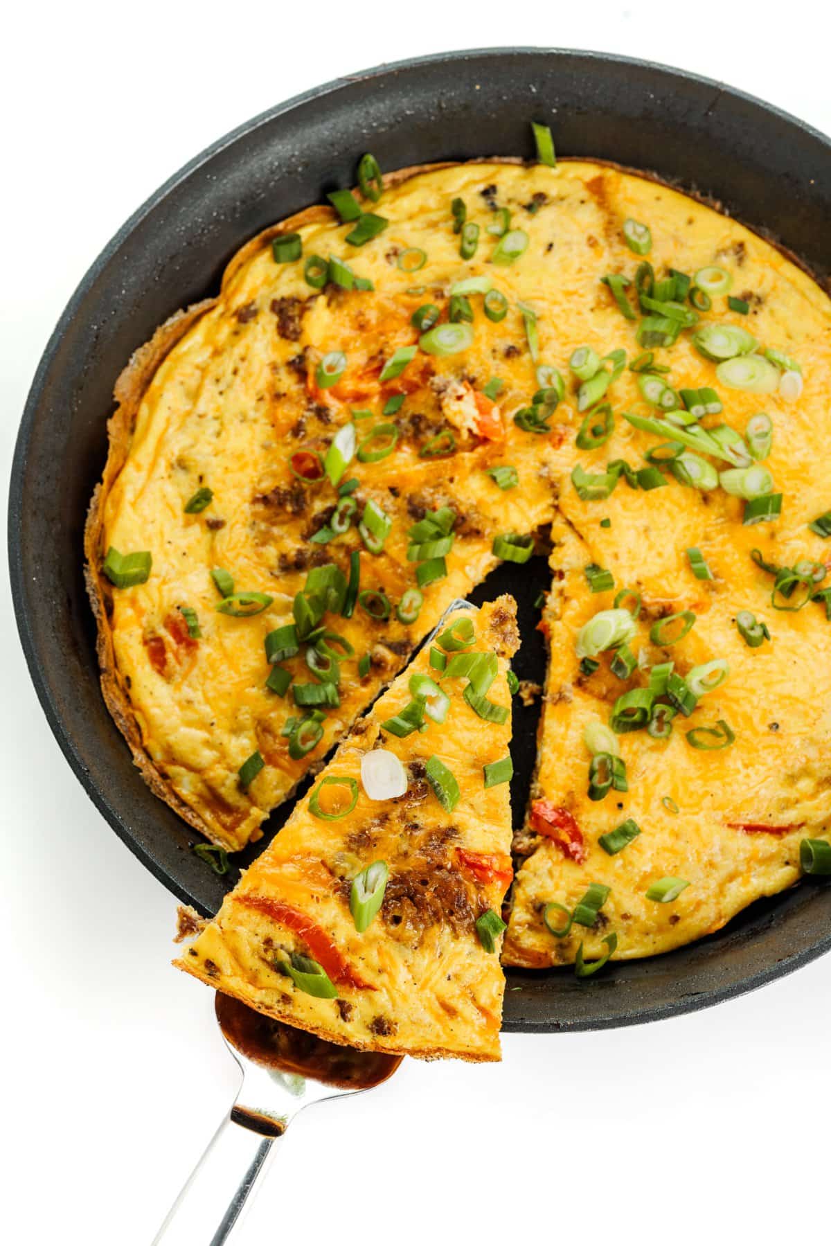 Serving a slice of an easy breakfast frittata.
