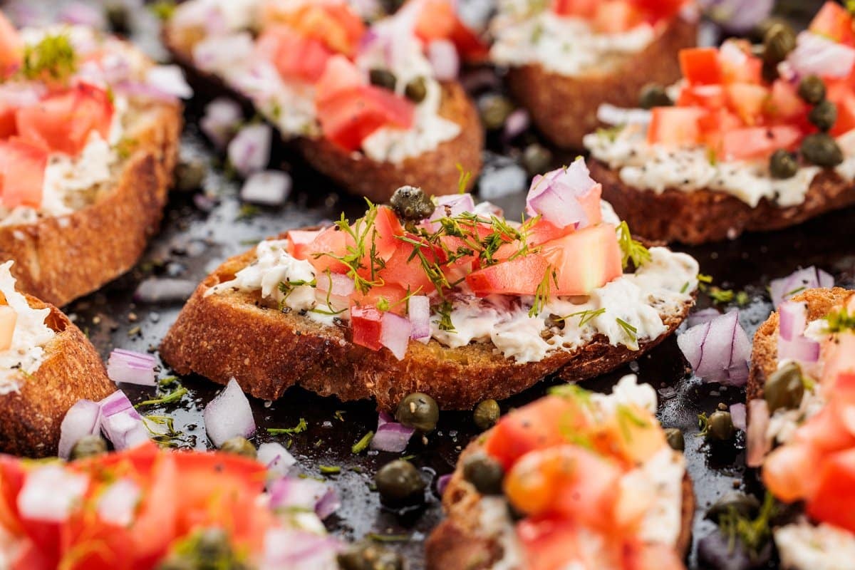 Smoked salmon crostini on a baking sheet.
