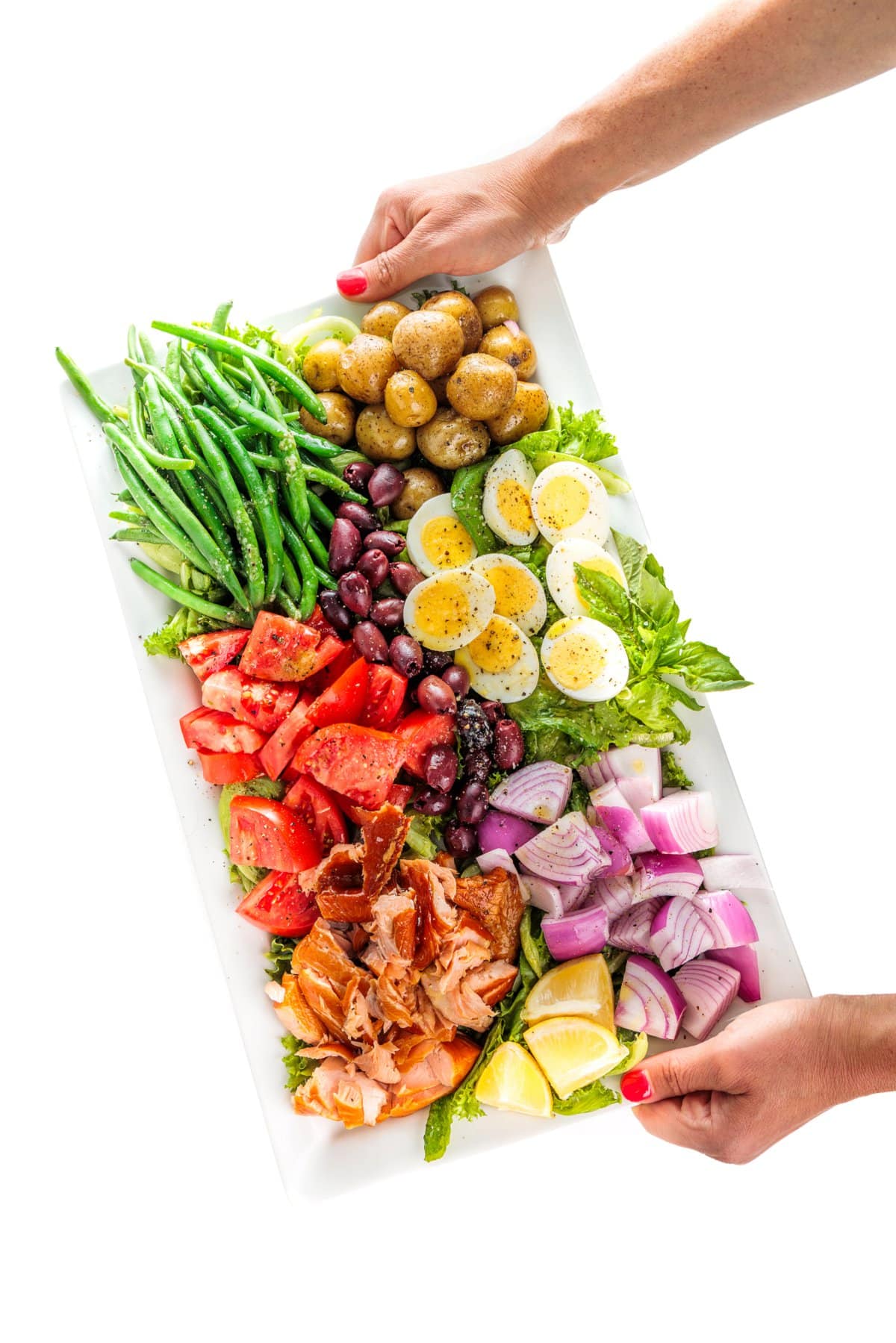 Holding a smoked salmon nicoise salad.