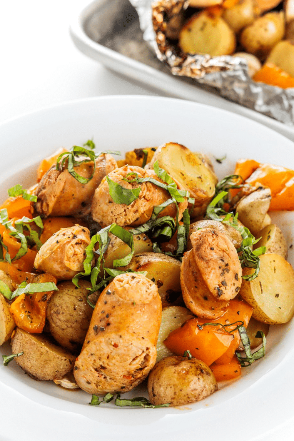 Grilled sausage, peppers, and potatoes up close.
