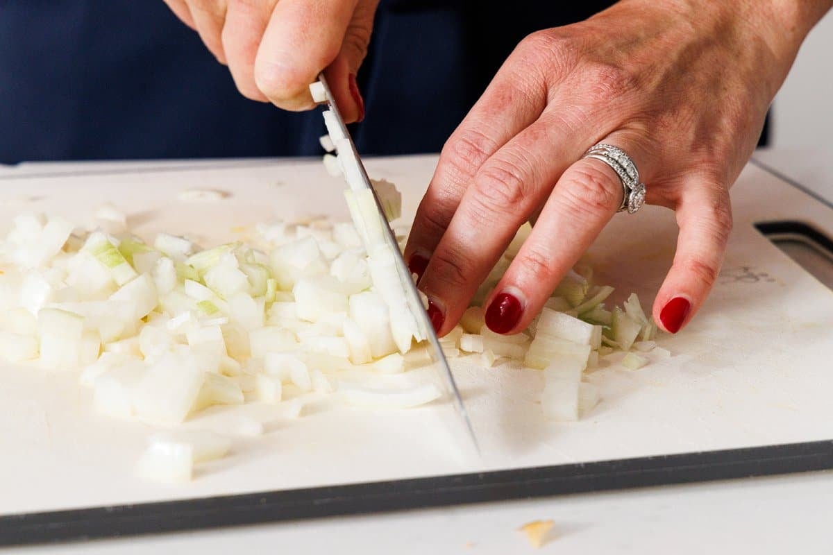 Liz dicing a white onion.