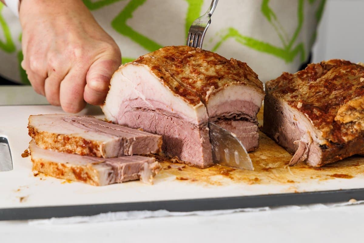 Cutting beef brisket into slices.