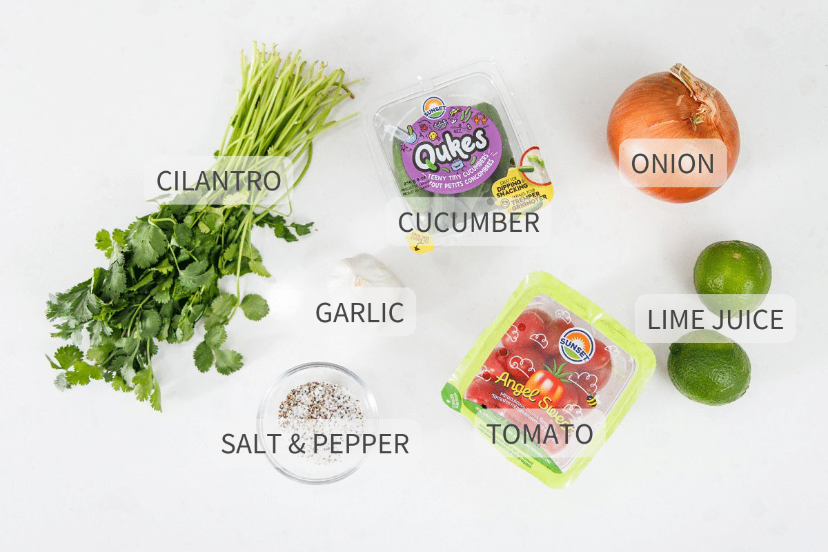 Labeled ingredients for cucumber pico de gallo against a white backdrop.