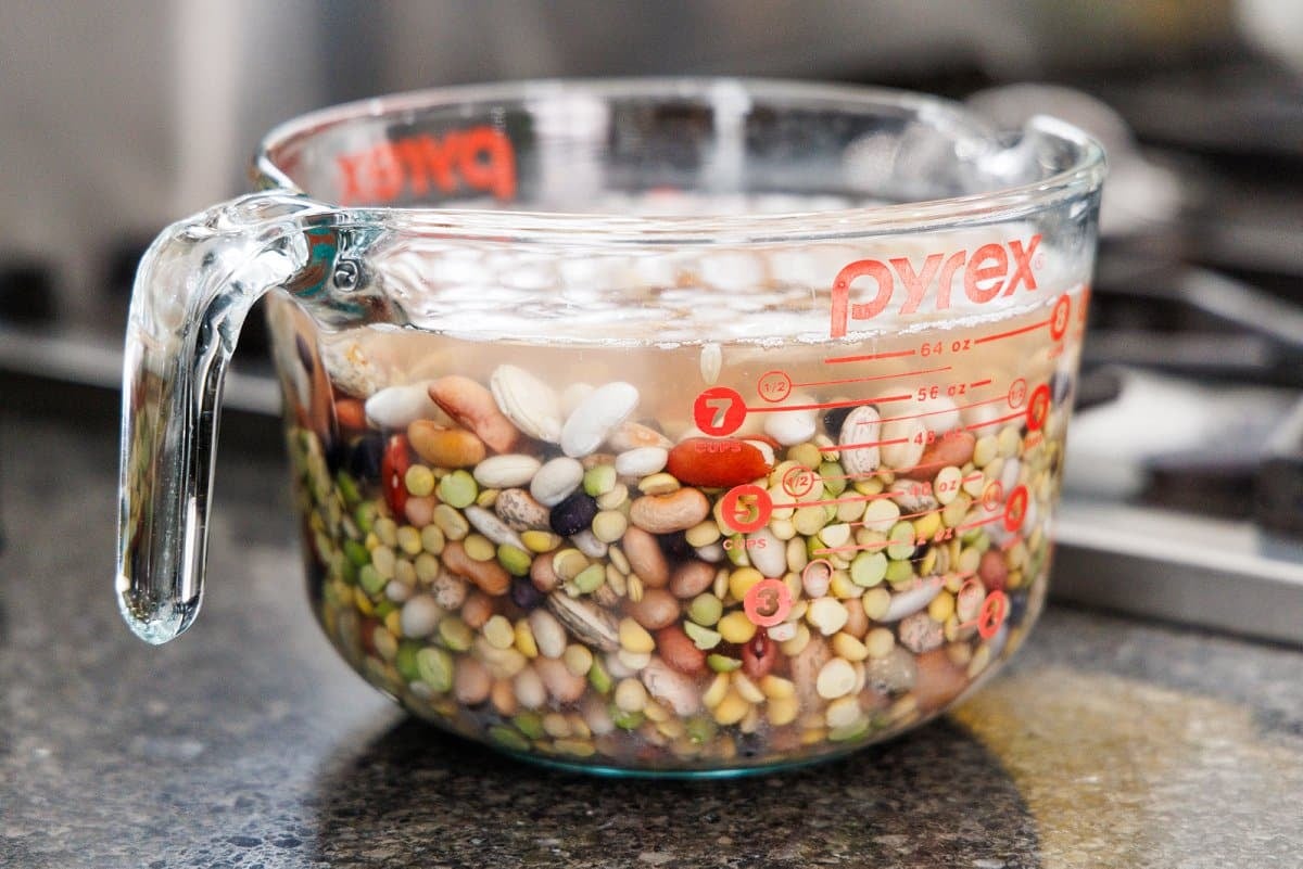 Soaking 15 bean soup mix in a pot of water.
