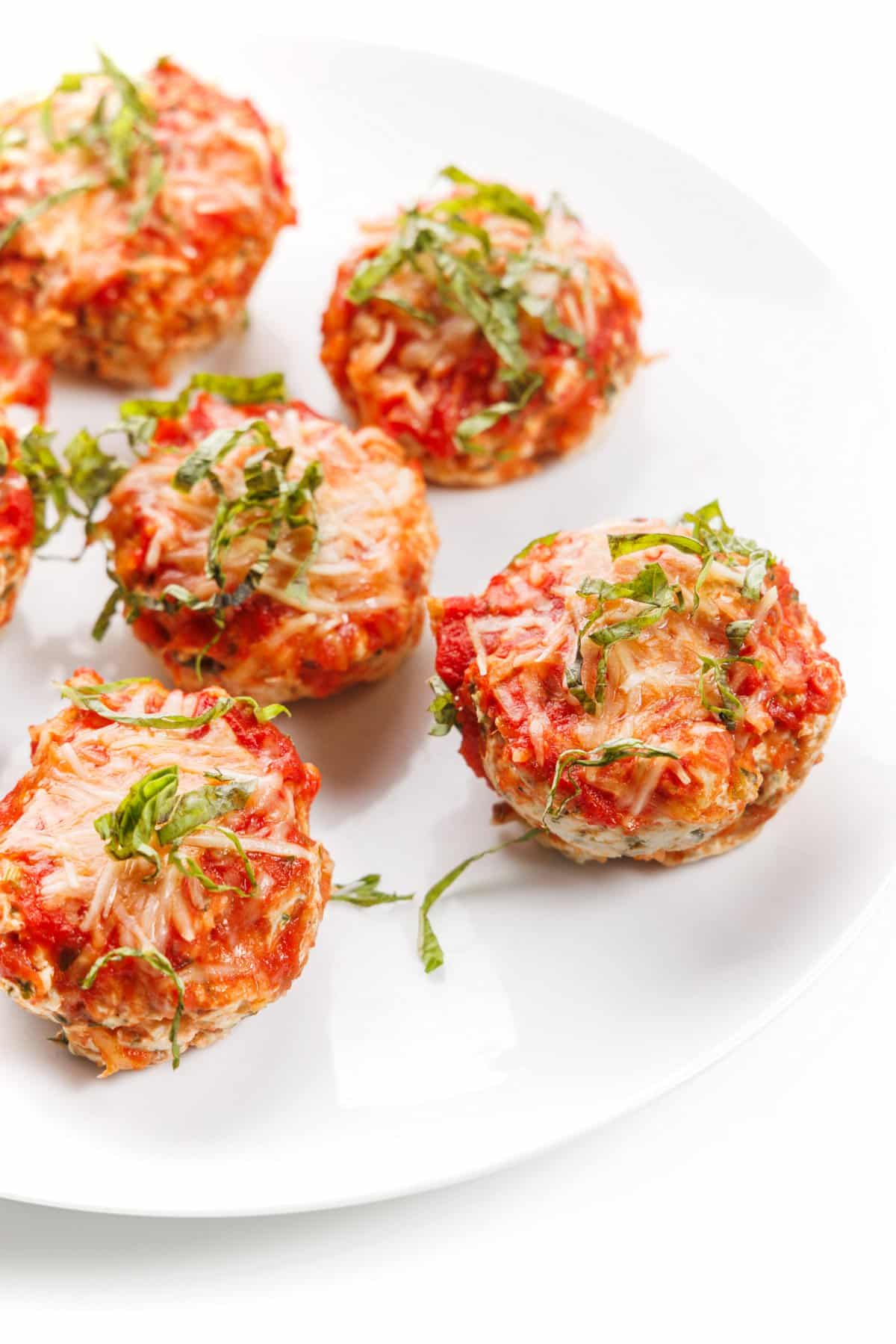 Plate full of chicken parm meatloaf muffins.