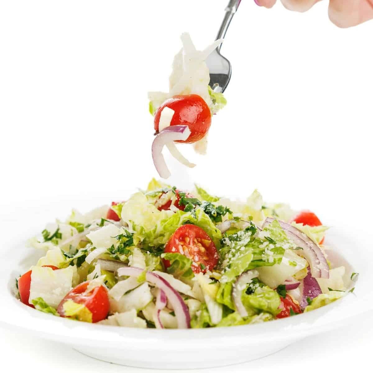 Forkful of Italian garden salad with fennel.