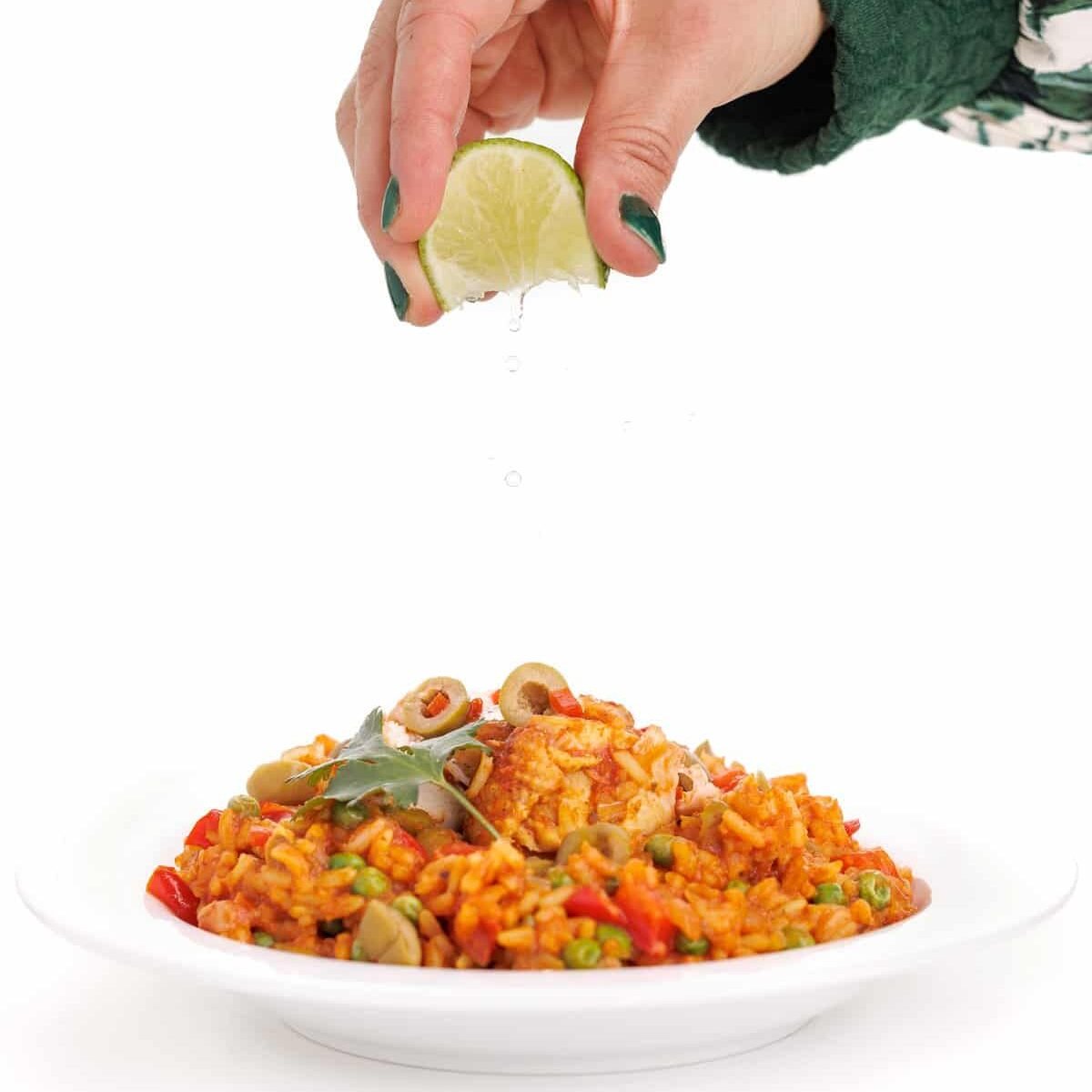 Liz garnishing slow cooker arroz con pollo.