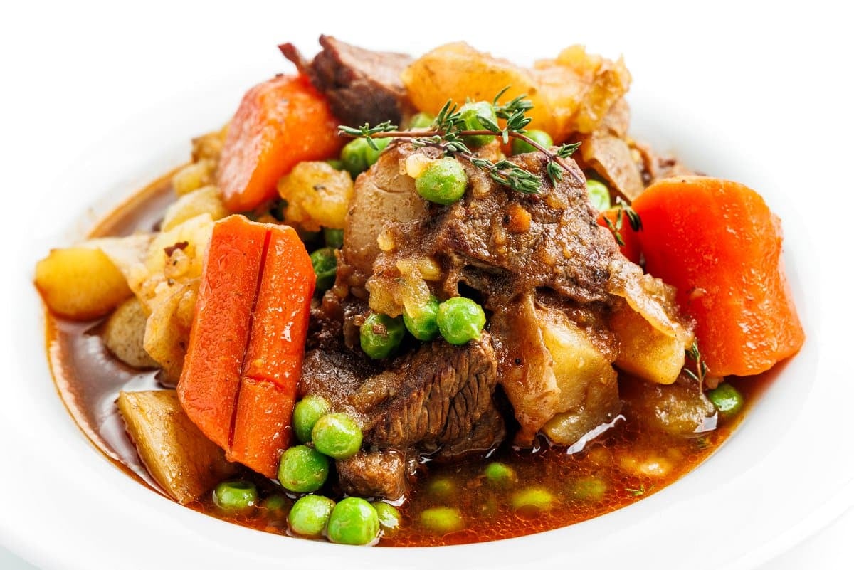 Irish beef stew in a white bowl.