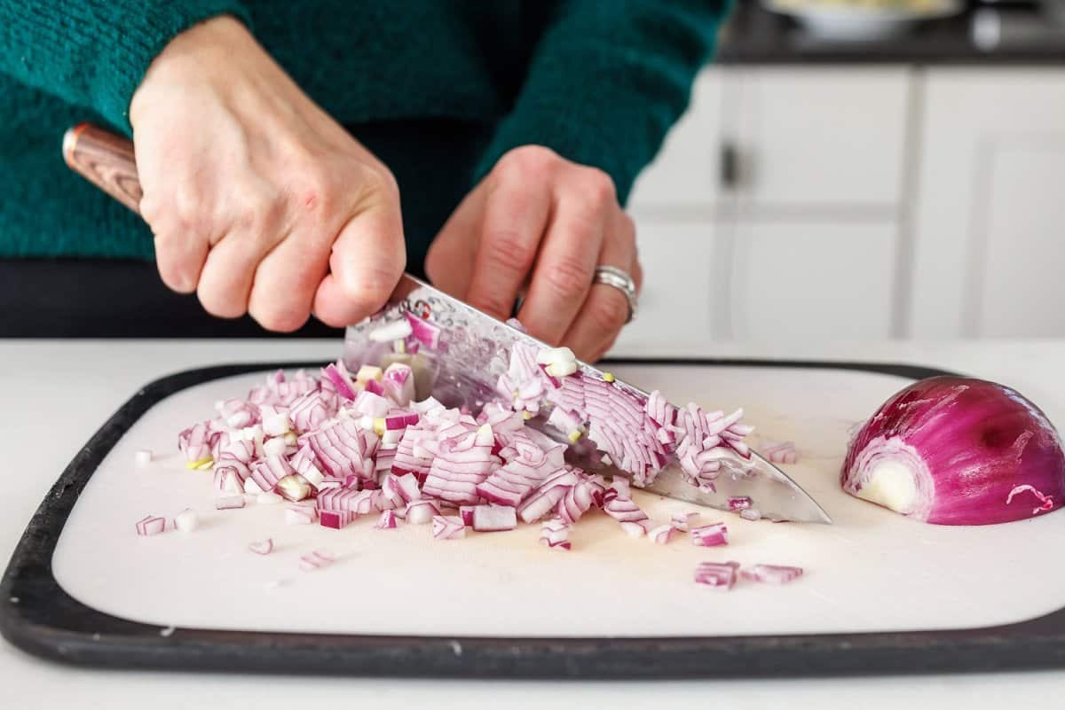 Liz dicing a red onion.
