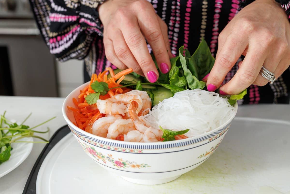 Putting together Vietnamese shrimp salad bowl.