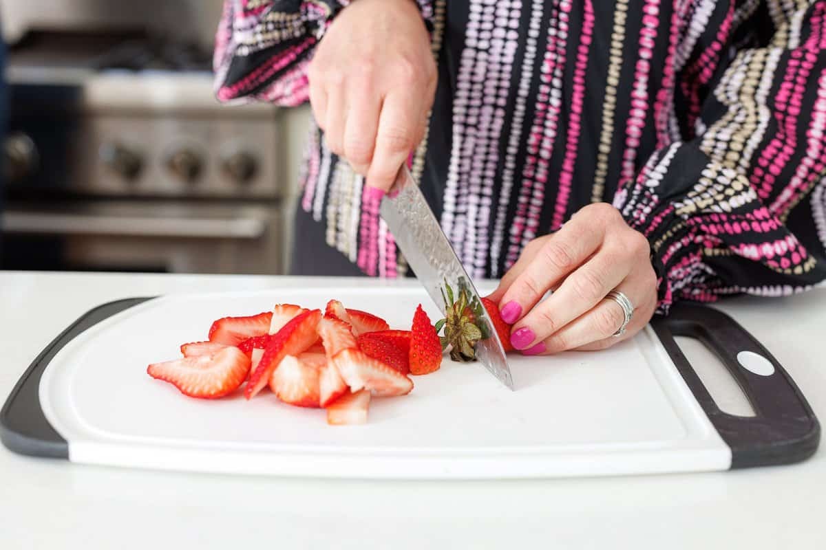 Liz cutting strawberries.