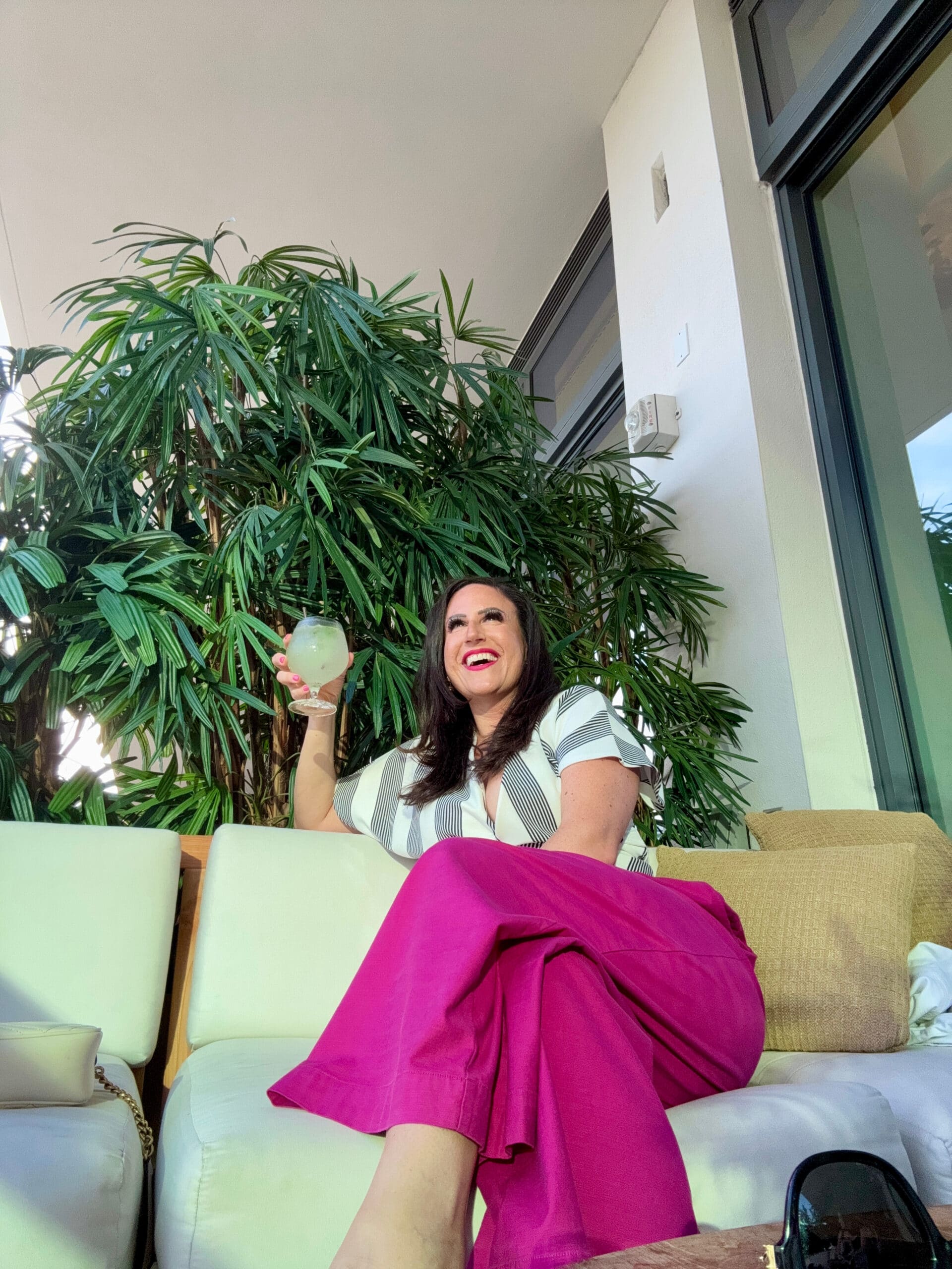 Liz sipping a cocktail at the rooftop lounge.