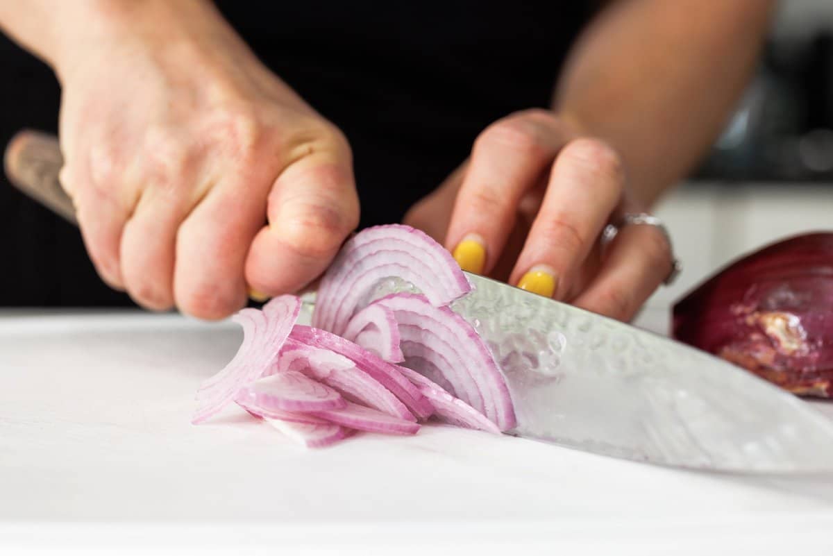 Liz slicing an onion.