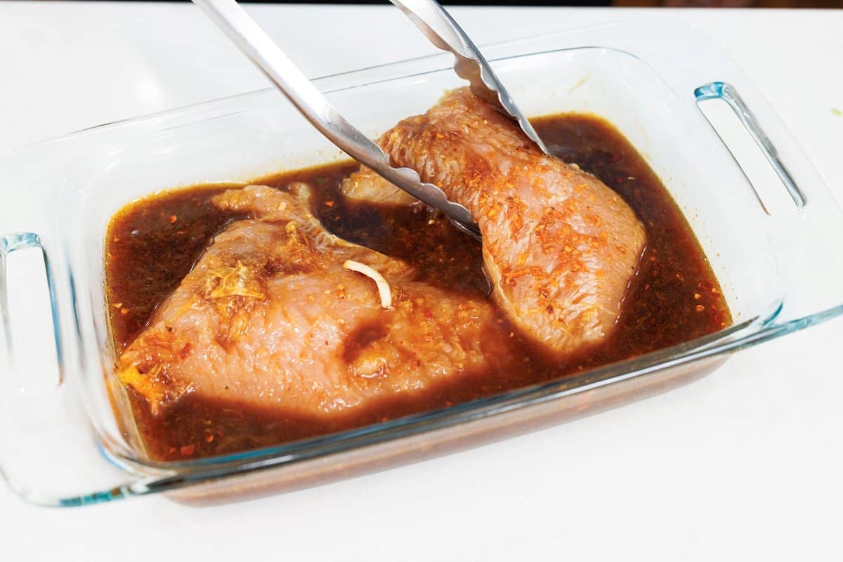 Turkey tenderloins sitting in teriyaki marinade.