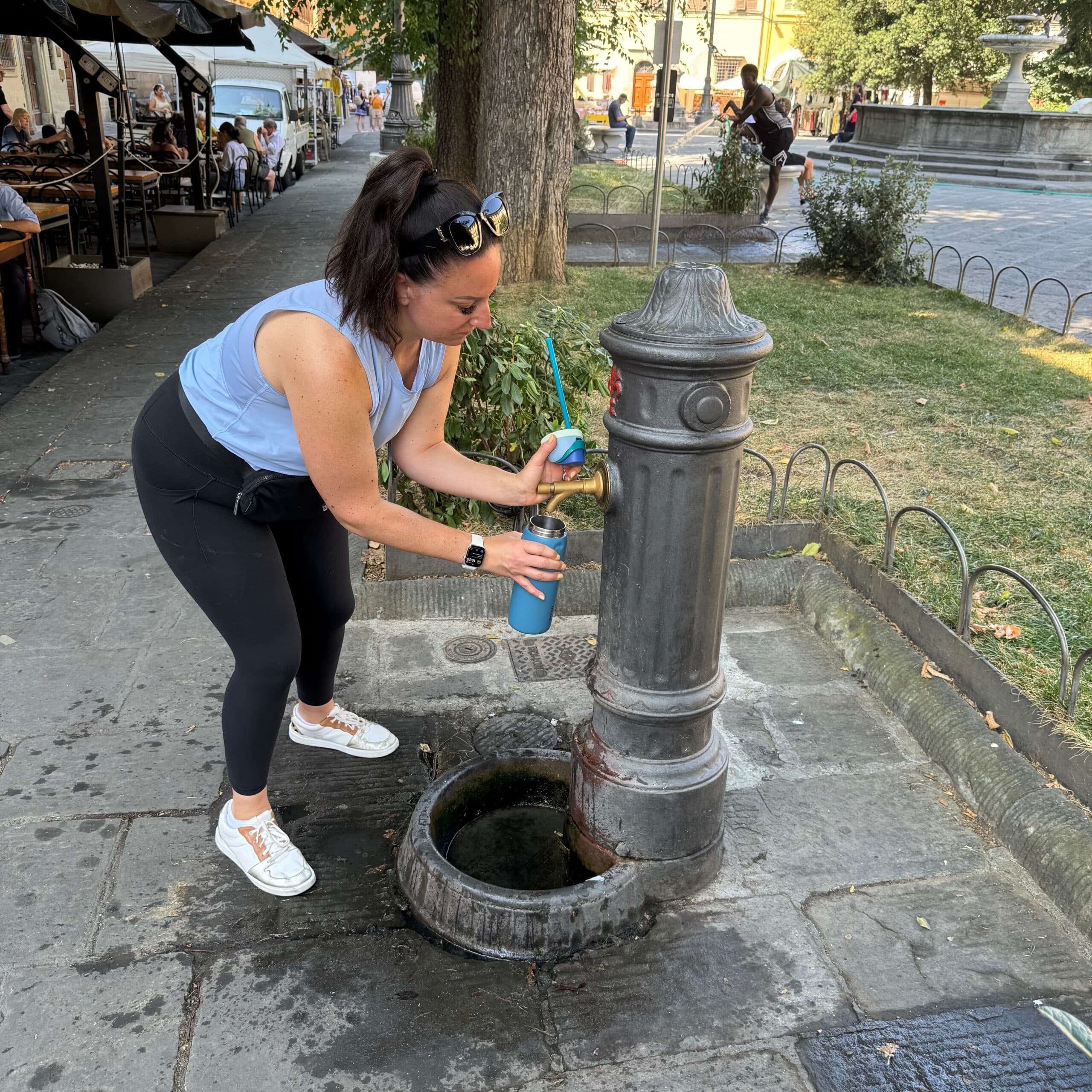 Liz refilling water bottle at public fountain.