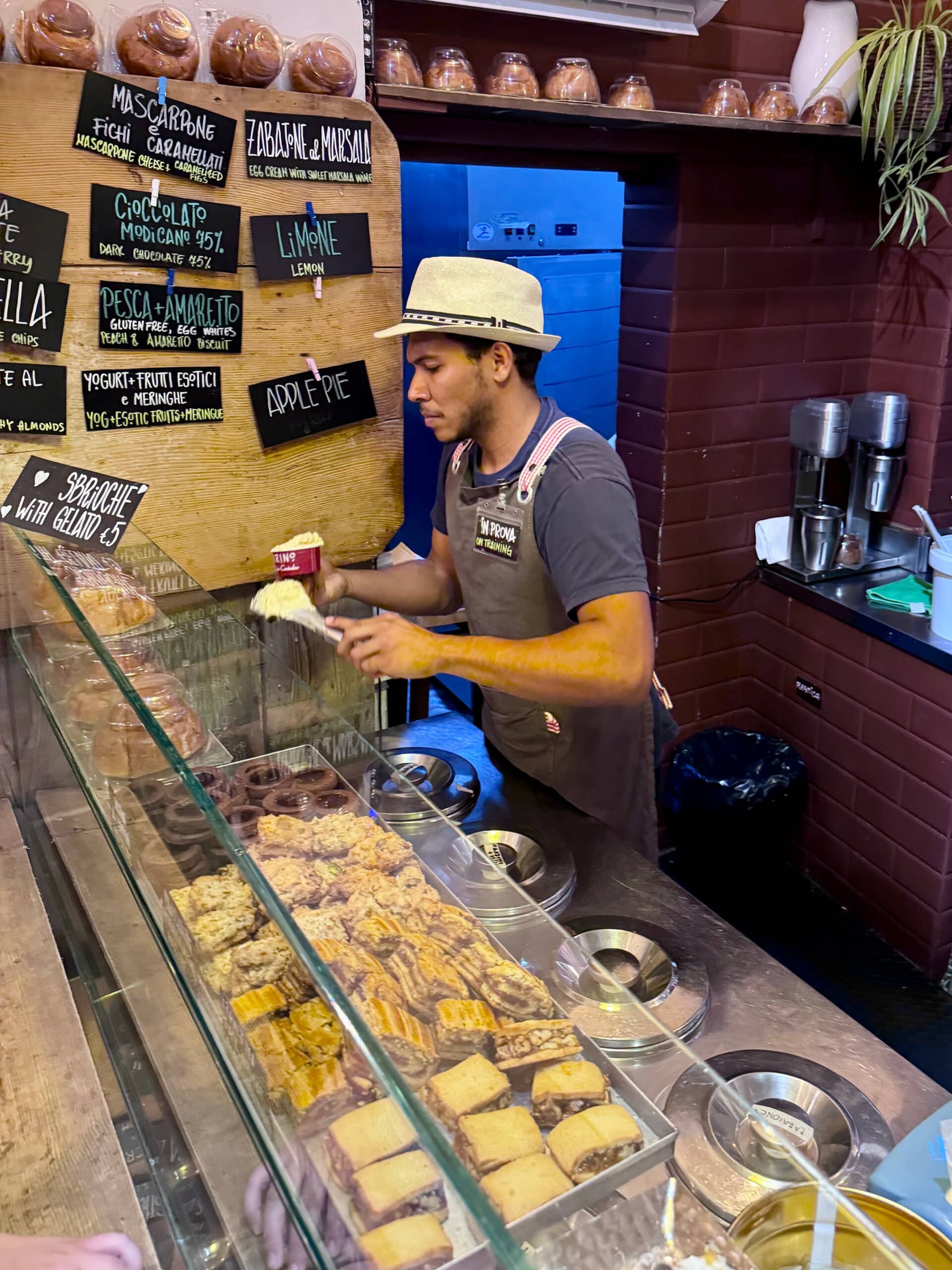 Authentic gelato shop, with gelato kept in steel lid containers.