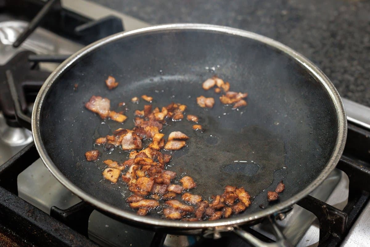 Frying bacon in a pan.