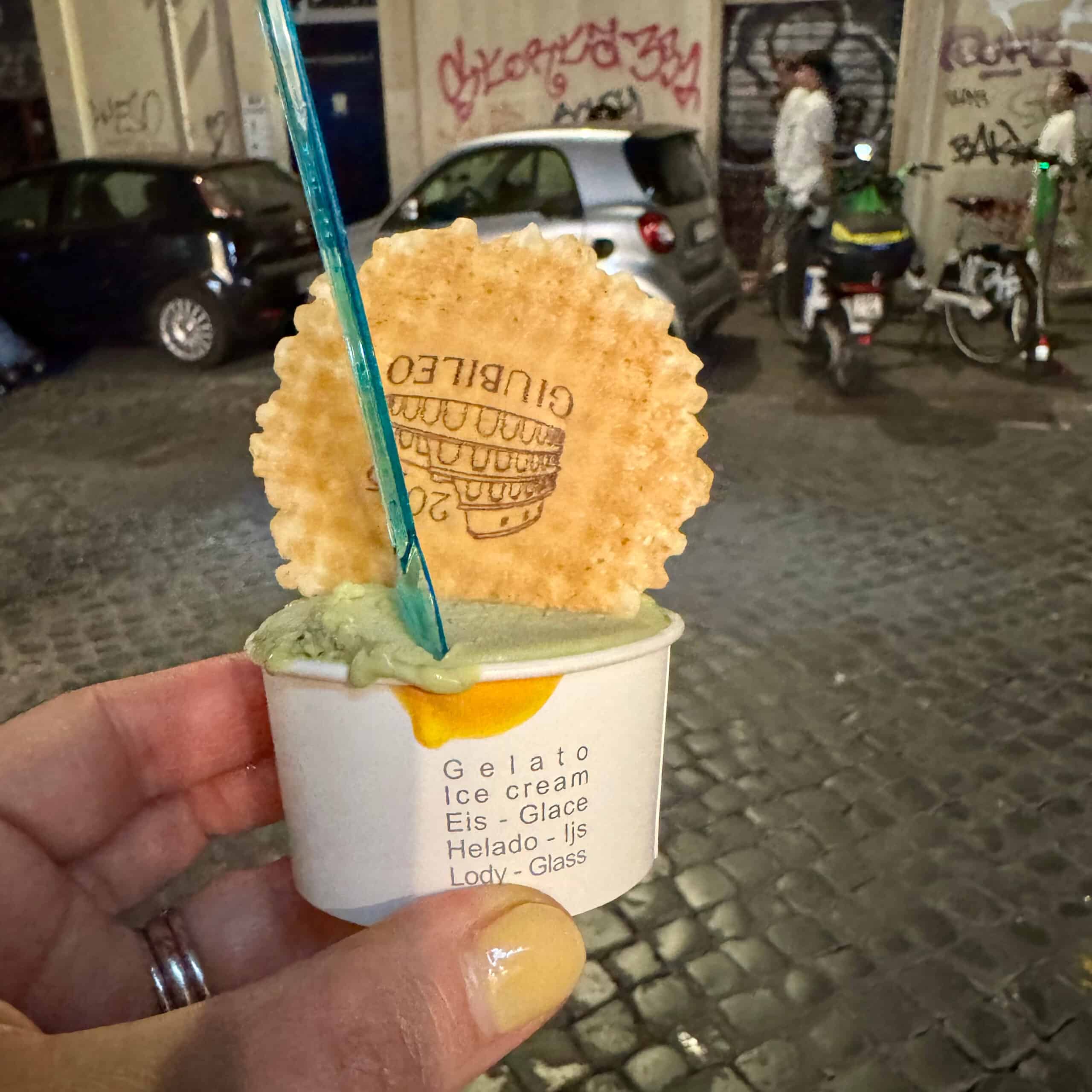 Holding a small cup of gelato in the streets of Rome.
