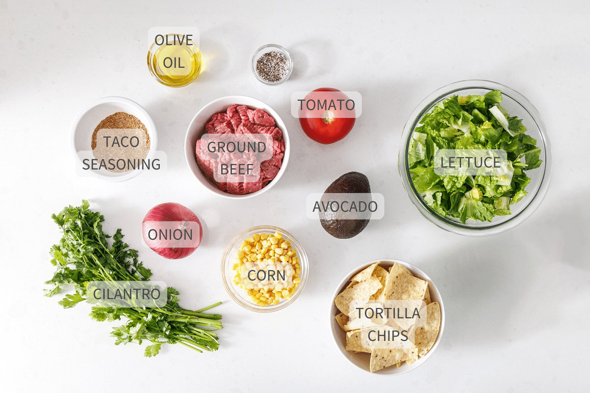 Labeled ingredients for taco salad bowls with ground beef.