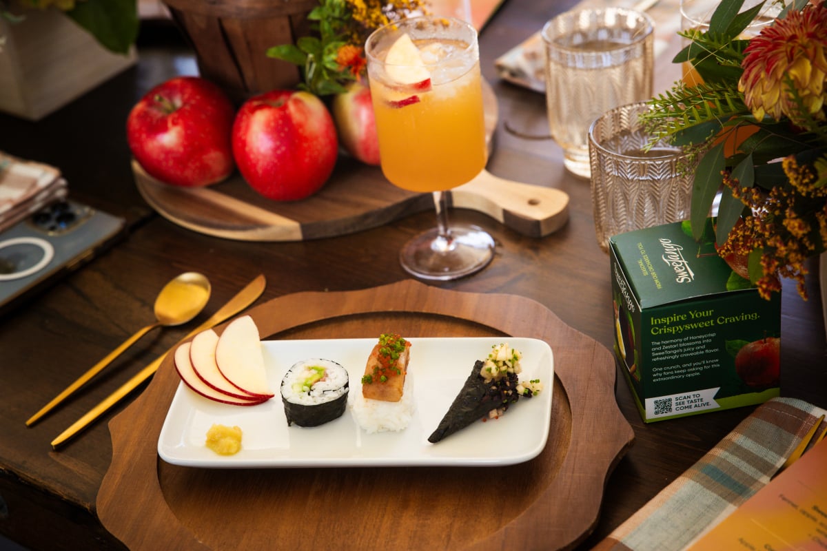 Tasting plate on a table with an apple cider and fresh apples.